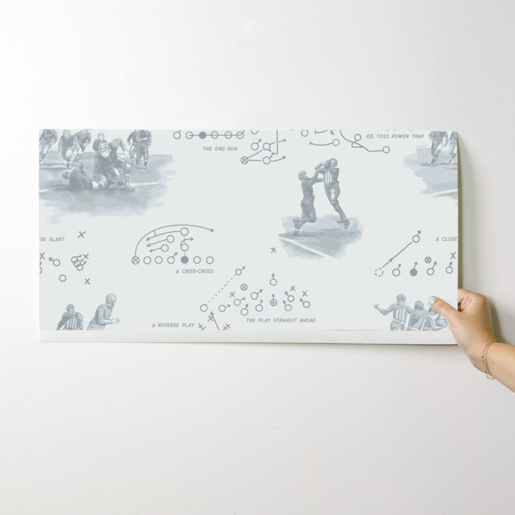 Wallpaper swatch showing vintage football playbook design in pewter gray. Order before committing to full rolls