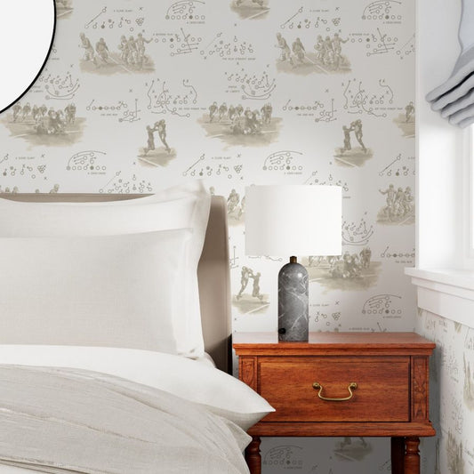 Warm sepia vintage football wallpaper in a classic bedroom with walnut nightstand and brass lamp — antique sports wallpaper for bedrooms