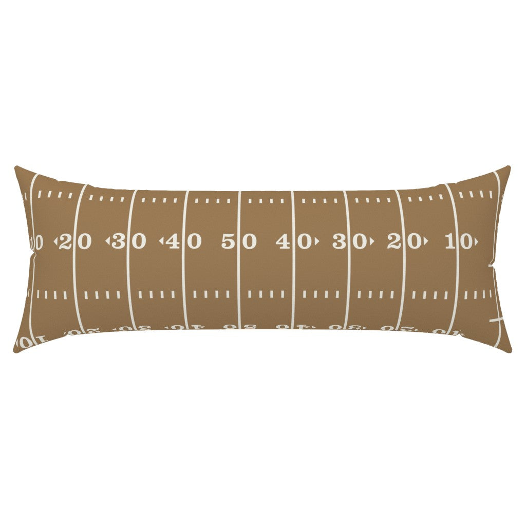 Stadium Stripes gold lumbar pillow cover full view — gold football lumbar pillow in warm gold and white on white background