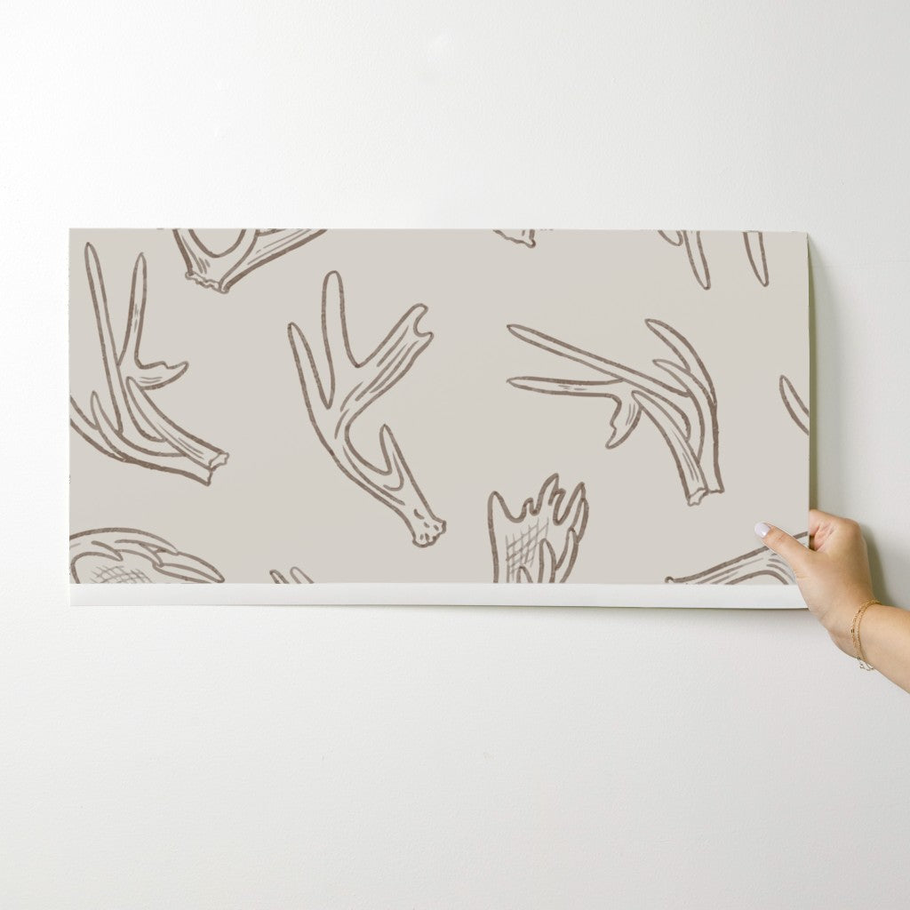 Antler Dance wallpaper swatch in Bone Canyon — warm neutral antler wallpaper by Pine + Feather Studio