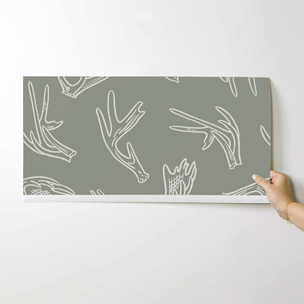 Antler Dance wallpaper swatch in Sage Ridge — sage green antler wallpaper by Pine + Feather Studio