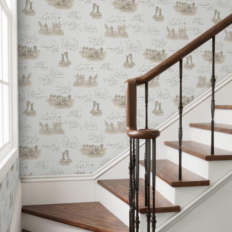 Peel and stick football wallpaper in sepia on a staircase wall — vintage sports wallpaper for hallways and entryways