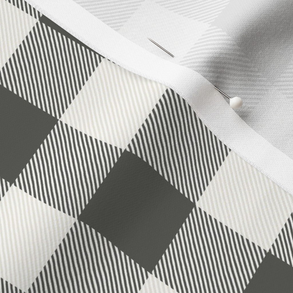 Close-up of the Cabin Check buffalo check fabric in Charcoal on cotton sateen, showing the drawn twill texture