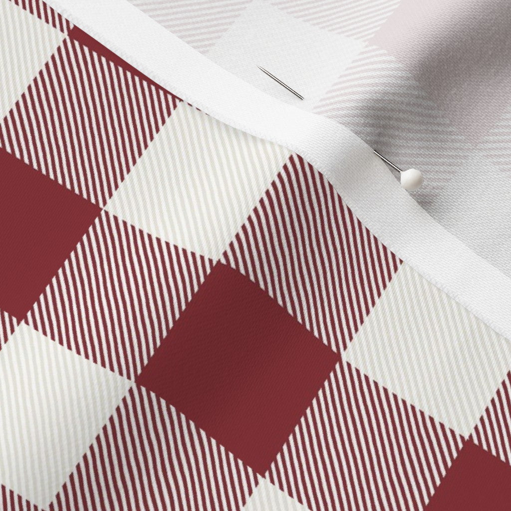 Close-up of the Cabin Check buffalo check fabric in Cranberry Red on cotton sateen, showing the drawn twill texture