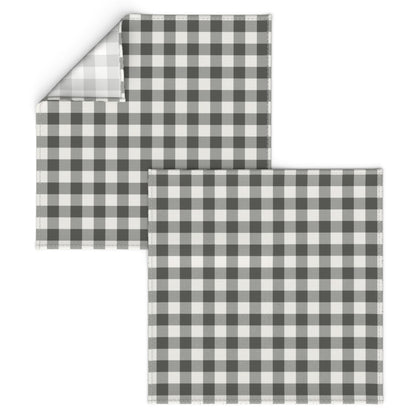 Corner of a charcoal buffalo check napkin turned back to show the folded hem