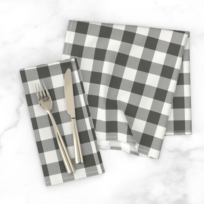 Charcoal buffalo check dinner napkin with a knife and fork on a white marble tabletop