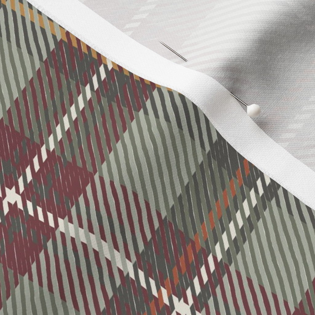 Close-up of the Homestead Plaid fabric in Holiday Berry on cotton sateen, showing the cranberry, sage and charcoal tartan and the fabric's smooth weave