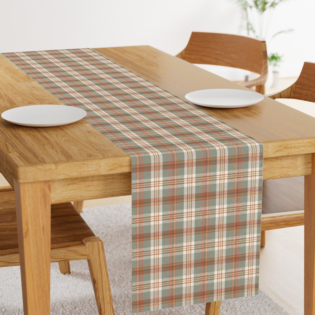 Rust, sage and cream plaid table runner on a dining table