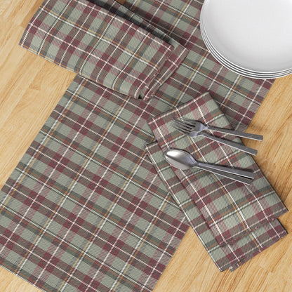 Top-down view of the Holiday Berry plaid runner with matching napkins, plates and flatware