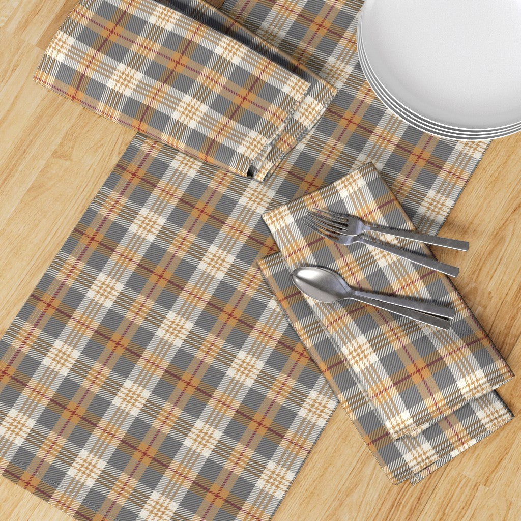 Top-down view of the Winter Hearth plaid runner with matching napkins, plates and flatware