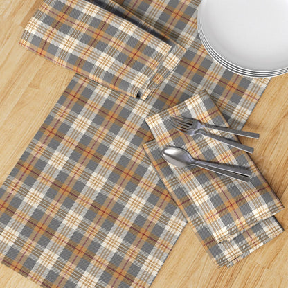Top-down view of the Winter Hearth plaid runner with matching napkins, plates and flatware