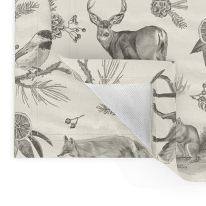 Close-up of the charcoal toile placemat corner showing the folded hem and unprinted back