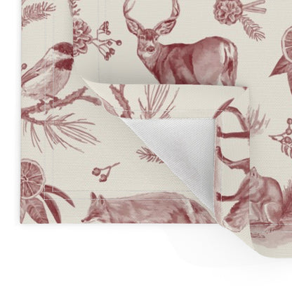 Close-up of the cranberry toile placemat corner showing the folded hem and unprinted back